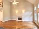 Spacious living room with hardwood floors, a fireplace, and arched windows at 6680 Bentley Trl, Cumming, GA 30040