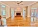 Spacious living room with hardwood floors, fireplace, and lots of natural light at 6680 Bentley Trl, Cumming, GA 30040