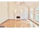 Spacious living room featuring hardwood floors, fireplace and lots of natural light at 6680 Bentley Trl, Cumming, GA 30040