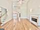 Open living room with hardwood floors, fireplace and large windows at 6680 Bentley Trl, Cumming, GA 30040