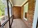 View of the screened in porch with brick walls and wood flooring at 6680 Bentley Trl, Cumming, GA 30040