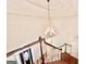 View of the wooden staircase featuring a decorative chandelier at 6680 Bentley Trl, Cumming, GA 30040