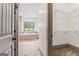 Bathroom view through doorway of soaking tub and tiled floors, also showing a walk-in closet at 1233 Butler Bridge Rd, Mcdonough, GA 30252