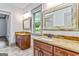 Beautiful bathroom featuring double vanity with granite countertops and decorative framed mirrors at 1233 Butler Bridge Rd, Mcdonough, GA 30252