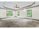 A carpeted bedroom has a trey ceiling and crown molding, with three large windows offering ample natural light at 1233 Butler Bridge Rd, Mcdonough, GA 30252