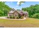 Charming brick home featuring manicured landscaping and a welcoming front porch at 1233 Butler Bridge Rd, Mcdonough, GA 30252