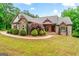 Charming brick home featuring manicured landscaping and a welcoming front porch at 1233 Butler Bridge Rd, Mcdonough, GA 30252