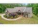 Charming brick home featuring manicured landscaping and a welcoming front porch at 1233 Butler Bridge Rd, Mcdonough, GA 30252