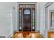 Elegant wooden front door with decorative glass panels and sidelights at 1233 Butler Bridge Rd, Mcdonough, GA 30252