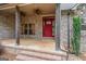 Inviting covered front porch with brick columns and detailed front door at 1233 Butler Bridge Rd, Mcdonough, GA 30252