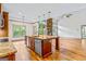 A spacious kitchen island features a granite countertop, stainless steel appliances and wood flooring at 1233 Butler Bridge Rd, Mcdonough, GA 30252