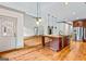 Open kitchen and living room area featuring a stainless steel fridge and a kitchen island at 1233 Butler Bridge Rd, Mcdonough, GA 30252