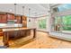 Modern kitchen featuring wooden cabinets, an island, recessed lighting, and a tray ceiling at 1233 Butler Bridge Rd, Mcdonough, GA 30252