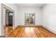 Bright living room with hardwood floors and a large window featuring a front door entrance at 1233 Butler Bridge Rd, Mcdonough, GA 30252