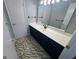 Bright bathroom featuring vanity with sink, mirror and tiled floors at 1329 Springwood Nw Dr, Conyers, GA 30012