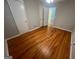 Bedroom features hardwood floors with a open door leading to another room at 1329 Springwood Nw Dr, Conyers, GA 30012