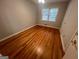 Bedroom features hardwood floors and natural light from the window at 1329 Springwood Nw Dr, Conyers, GA 30012