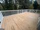 Exterior wooden deck with decorative white railing overlooking surrounding trees at 1329 Springwood Nw Dr, Conyers, GA 30012