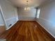 Well-lit dining area showcasing hardwood floors, a chandelier, and traditional wainscoting at 1329 Springwood Nw Dr, Conyers, GA 30012