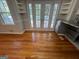 Bright dining area featuring hardwood floors, built-in shelves, and double doors leading to the outdoors at 1329 Springwood Nw Dr, Conyers, GA 30012