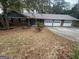 Charming one-story home with a brick facade and an attached three-car garage at 1329 Springwood Nw Dr, Conyers, GA 30012
