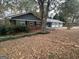 A charming one-story home with brick and blue siding and a yard covered in fall leaves at 1329 Springwood Nw Dr, Conyers, GA 30012