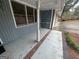 Covered porch with brick flooring, blue siding, and white support columns at 1329 Springwood Nw Dr, Conyers, GA 30012