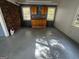 Attached garage featuring cabinets, storage and work area with painted floor at 1329 Springwood Nw Dr, Conyers, GA 30012