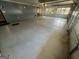 Spacious garage offers ample parking with gray painted floors and neutral-toned walls at 1329 Springwood Nw Dr, Conyers, GA 30012