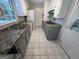 Galley kitchen featuring tile floors, gray cabinets, updated appliances, and ample counter space at 1329 Springwood Nw Dr, Conyers, GA 30012