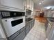 Well-equipped kitchen featuring gray cabinets, updated appliances, and adjacent to dining area at 1329 Springwood Nw Dr, Conyers, GA 30012