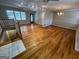 Open-concept living room featuring hardwood floors, neutral walls, and staircase access at 1329 Springwood Nw Dr, Conyers, GA 30012