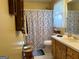Bathroom featuring a vanity, toilet, and shower with a decorative blue and white shower curtain at 712 Honeysuckle Ln, Temple, GA 30179