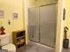 Bathroom with shower stall, complemented by a convenient storage shelf and neutral fixtures at 712 Honeysuckle Ln, Temple, GA 30179
