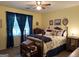 Bright bedroom featuring a ceiling fan, bedside table, and comfortable decor at 712 Honeysuckle Ln, Temple, GA 30179