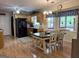 Bright kitchen and dining area featuring wood floors, wood cabinets, and modern appliances at 712 Honeysuckle Ln, Temple, GA 30179