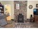 Living room with wood burning stove and attractive stone wall at 712 Honeysuckle Ln, Temple, GA 30179