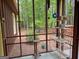 Quaint screened porch boasts views of the lush surroundings, and a serene space for outdoor enjoyment at 712 Honeysuckle Ln, Temple, GA 30179