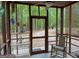 Charming screened porch provides a tranquil view of the wooded backyard, perfect for outdoor relaxation at 712 Honeysuckle Ln, Temple, GA 30179