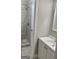 Bathroom featuring tiled shower, vanity with sink and decorative mirror at 1607 Hillview Ave, Jonesboro, GA 30236