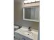 Bathroom featuring white vanity with modern faucet and a large, framed mirror at 1607 Hillview Ave, Jonesboro, GA 30236