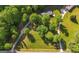 An aerial view of a lush green property with a winding driveway and mature trees at 292 S Prospect Ave, Waco, GA 30182