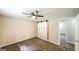 This bedroom features a ceiling fan, plush carpeting, and a decorative sliding closet door at 292 S Prospect Ave, Waco, GA 30182
