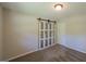 A bright bedroom features a sliding closet door, carpet floors, and a ceiling fan at 292 S Prospect Ave, Waco, GA 30182