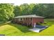 Brick home with a lush, green lawn and mature trees, plus a convenient drive-under garage at 292 S Prospect Ave, Waco, GA 30182