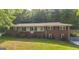 Charming brick home with a welcoming front porch and a well-maintained lawn at 292 S Prospect Ave, Waco, GA 30182