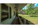 Covered front porch with view of American flag and black-shuttered windows at 292 S Prospect Ave, Waco, GA 30182