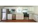 Well-equipped kitchen with stainless steel appliances, white cabinets, and sleek countertops at 292 S Prospect Ave, Waco, GA 30182