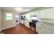 Modern kitchen with stainless steel appliances, granite countertops, and wood flooring at 292 S Prospect Ave, Waco, GA 30182