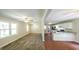 Open-concept layout with stylish flooring and adjacent kitchen featuring a breakfast bar at 292 S Prospect Ave, Waco, GA 30182